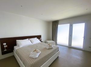 a bedroom with a bed with two towels on it at Agricola Chiani in Melendugno