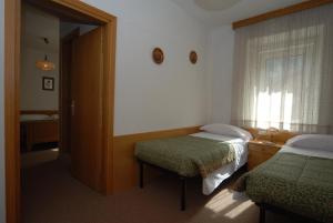Postel nebo postele na pokoji v ubytování Hotel Ancora