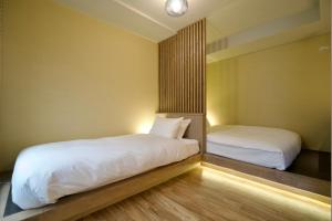 two beds in a small room with white sheets at Grand Success Kotoni V in Kotoni