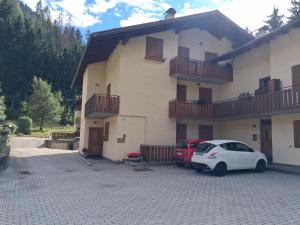 a white car parked in front of a house at Casa Tullia by Go New Location in Ziano di Fiemme