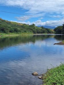 a view of a river with trees in the background at theoutbackhotel in Tonge