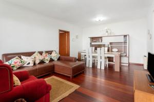 a living room with a couch and a table at Blissful Haven - Soulful Stays in Ilhéu Mole +17 photos