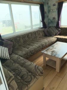 Una sala de estar con un sofá y una mesa de café. en B8 The chase caravan park, caravan ref B 3 Bed 8 Berth, en Ingoldmells 15 fotos más