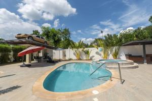 a swimming pool with a car on top of a house at La Vega Villa with Private Pool and BBQ in Santo Cerro
