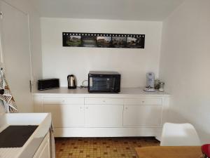 a kitchen with a counter with a microwave on it at Aubocoteau in Saint-Paterne-Racan +12 photos