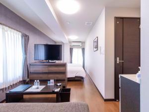 a hotel room with a bed and a flat screen tv at SA in Nagano Ishido - Vacation STAY 10215v in Nagano