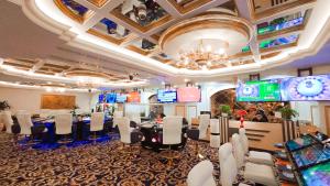 a conference room with tables and chairs and a chandelier at The IMPERIAL Vung Tau Hotel in Vung Tau