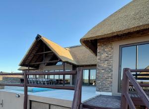Casa con techo de paja y piscina en Pezulu Lodge, en Bela-Bela