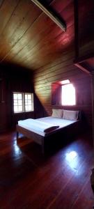 a bedroom with a bed in a wooden room at Babazia Community in Pai