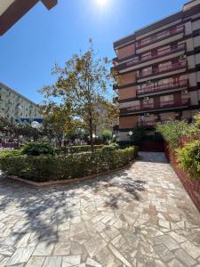 a building with a stone walkway in front of a building at Dimora in Fiore B&B in Foggia