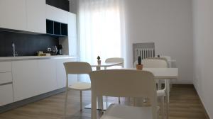 a kitchen with a table and chairs in a kitchen at Dimora in Fiore B&B in Foggia +24 photos