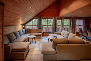 a living room with couches and tables and windows at Bakkebyvegen 7A in Trysil