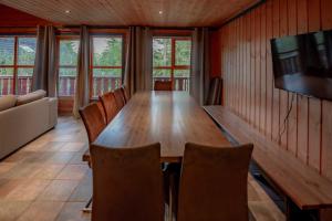 a dining room with a wooden table and chairs at Bakkebyvegen 7A in Trysil +9 photos