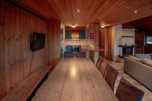 a dining room with a long wooden table and chairs at Bakkebyvegen 7A in Trysil