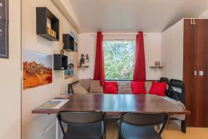 a living room with a table and a couch at Mobil-home in La Roque-dʼAnthéron