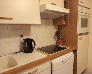 a small kitchen with a sink and a microwave at Appartement plein centre à 300m de la plage in Le Touquet-Paris-Plage