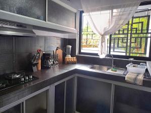 a kitchen with a sink and a window at Costa Verde Retreat 1 - Ground Floor in Quepos +19 photos