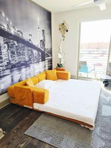 a bedroom with a large bed and a large window at Central Frisco Vibes 1 BR Apart With POOL & GYM in Frisco