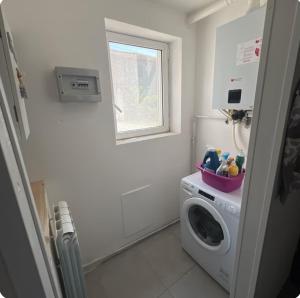 a laundry room with a washing machine and a window at Nido nel verde in Grazzano Visconti