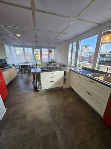 a large kitchen with white cabinets and a table at La Terrazza in Rome