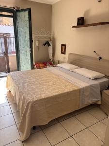 a bedroom with a large bed in a room at Il Cortiletto in Assemini