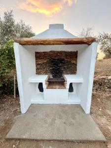 a fireplace is shown in a white building at Casa Papiqui in Fuenteheridos