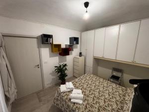 a bedroom with a bed with towels on it at Tranquillità a due passi dal centro 2 in Turin +3 photos