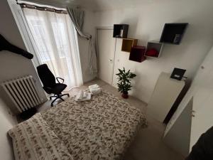 a bedroom with a bed and a chair and a window at Tranquillità a due passi dal centro 2 in Turin