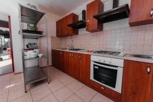 a kitchen with wooden cabinets and a stove top oven at Aura in Zatoka