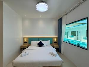 a bedroom with a large bed and a swimming pool at LVIS Pool Villa in Dharavandhoo