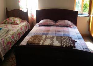 a bedroom with a bed and two pillows on it at Vila 1926 Entrepreneur in Polisi i Vogël +13 photos