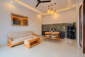 a living room with a couch and a table at Pondok Sura in Ubud