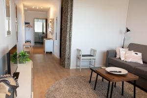 a living room with a couch and a table at Midtown Jeppis in Pietarsaari