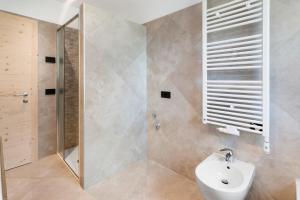 a bathroom with a shower and a toilet and a sink at Bait Dal Pa Livigno in Livigno +16 photos