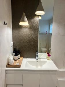 a bathroom with a white sink and a mirror at Sunny Matua, Private Suite, Quiet Stay, 5star Bed in Tauranga