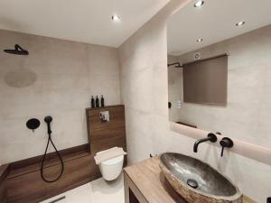 a bathroom with a sink and a toilet at Sea Whisper Luxury Apartments Kavala in Kavala +66 photos