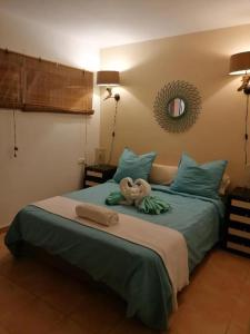 a bed with a stuffed animal on top of it at Duplex vue Océan in Costa de Antigua