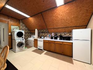 a kitchen with a refrigerator and a washer and dryer at The Avondale Attic in Chicago