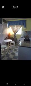 a kitchen with a table and a table and chairs at Lakaz in Port Louis