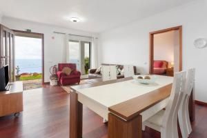 a kitchen and living room with a table and chairs at Blissful Haven - Soulful Stays in Ilhéu Mole