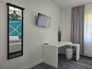 a bathroom with a mirror and a white desk at BTP House in Hunedoara