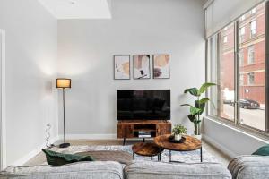 a living room with a couch and a table at Spacious 2BR CozySuites OTR Downtown #08 in Cincinnati