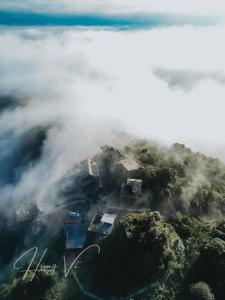 an island in the ocean covered in clouds at MiAmi Mountain Retreat in Bắc Yên
