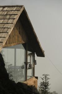a glass house with a gambrel roof at MiAmi Mountain Retreat in Bắc Yên
