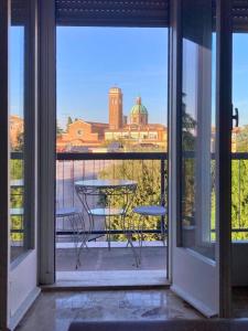 a balcony with a table and a view of a building at Vista Duomo Ravenna City Center Apartment in Ravenna