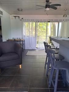 a living room with a couch and chairs and a table at Costa Verde Retreat 2 - Upper Floor in Quepos