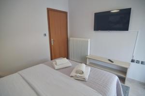 a bedroom with a bed with towels on it at Naya Lux Apt in Kastoria