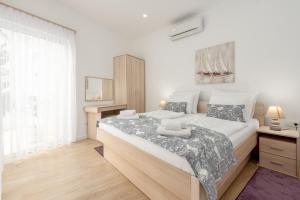 a white bedroom with a large bed in it at Unique luxury Villa Feriatum Lissa in Ždrelac +74 photos