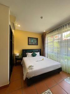 Postel nebo postele na pokoji v ubytování Nature Retreat Hoi An