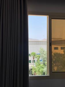 a window with a view of a building at بيت خزامى للشقق الفندقية المخدومة in Najran +3 photos